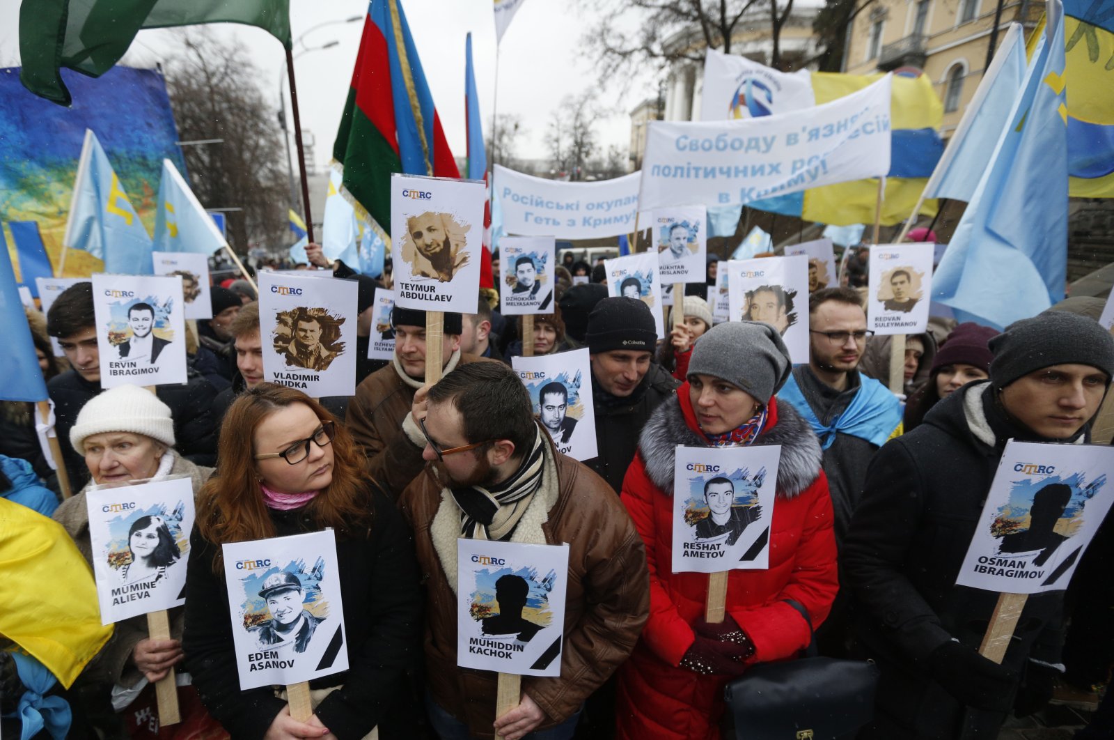 Ukrainian and Crimean Tatar activists hold portraits with the names of victims of the Russian annexation of Crimea during a rally, Kyiv, Ukraine, Feb. 26, 2017. (AP Photo)