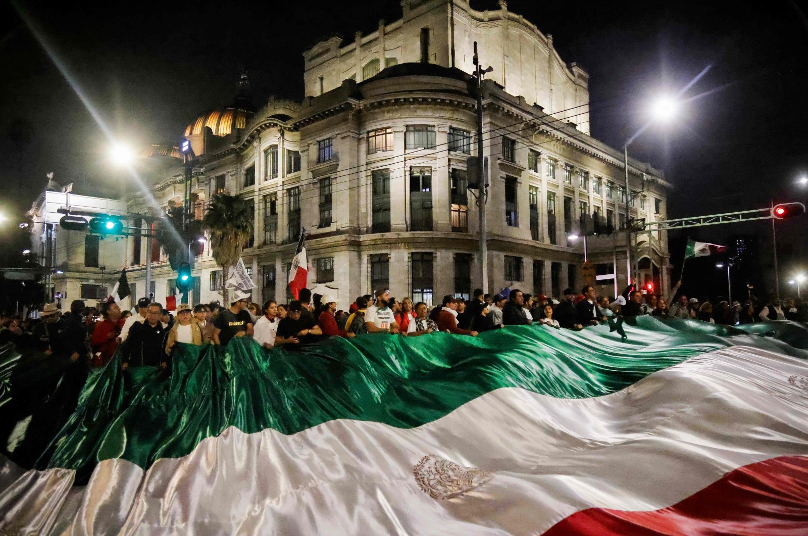 Judiciary workers and students hold a giant flag as they block the streets near the former headquarters of the Senate of Mexico, known as Casona de Xicotencatl, during a protest in Mexico City, Sept. 10, 2024. (AFP Photo)