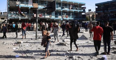 Palestinians walk in the courtyard of the Al-Jawni school after an Israeli airstrike hit the site, in Nuseirat in the central Gaza Strip, Palestine, Sept. 11, 2024. (AFP Photo)