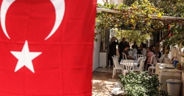 Relatives of Turkish American activist Ayşenur Ezgi Eygi, who was shot dead in the West Bank, sit in her grandfather's garden decorated with Turkish flags during a gathering to mourn her death, in the Didim district of Aydın, Türkiye, Sept. 11, 2024. (EPA Photo)