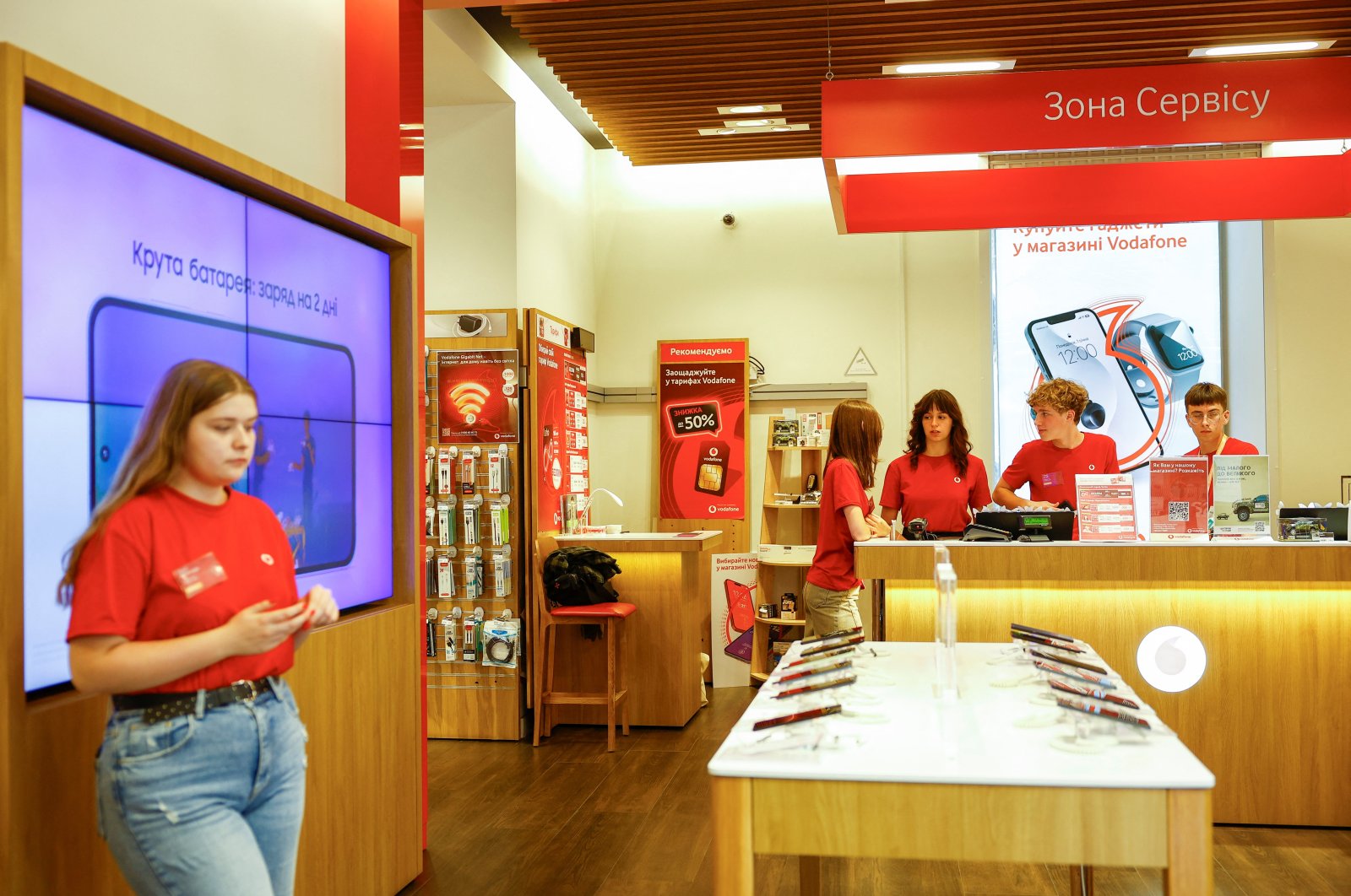 Teenagers work inside a branch of Vodafone mobile communication provider, Kyiv, Ukraine, Aug. 14, 2024. (Reuters Photo)