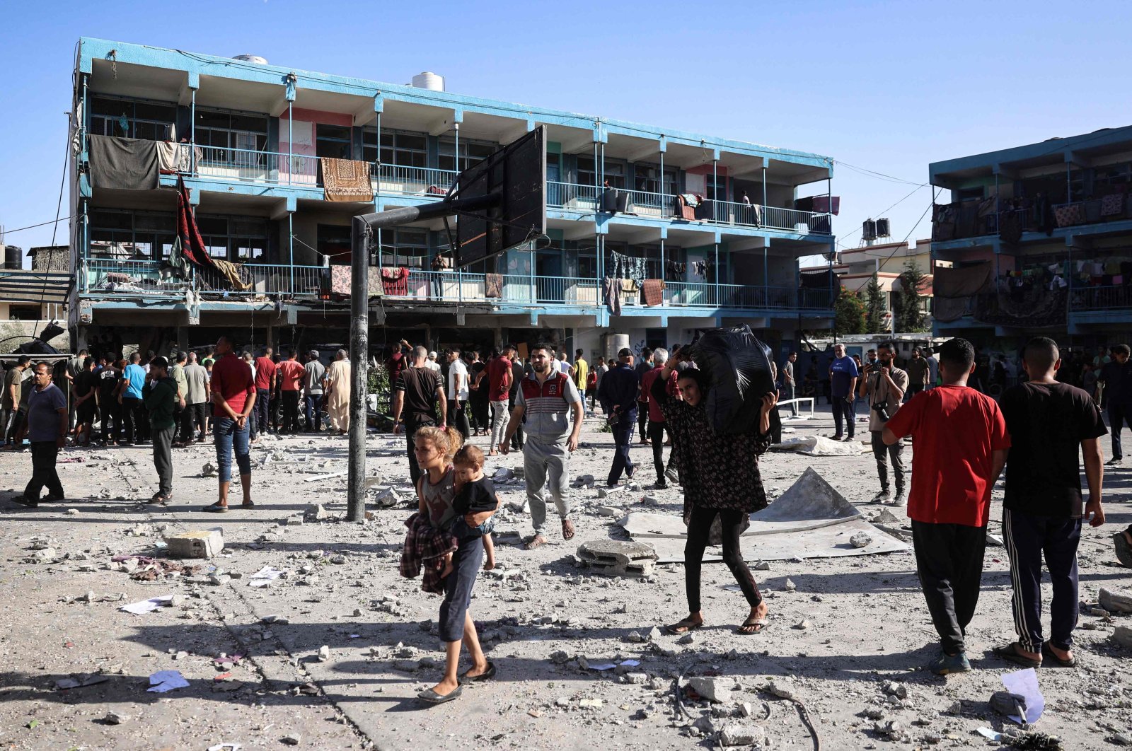 Palestinians walk in the courtyard of the Al-Jawni school after an Israeli airstrike hit the site, in Nuseirat in the central Gaza Strip, Palestine, Sept. 11, 2024. (AFP Photo)