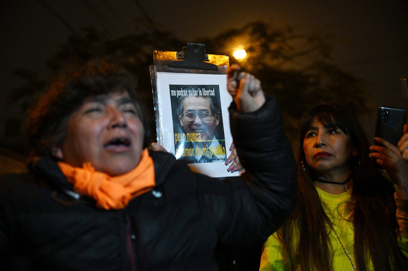 Supporters of former Peruvian President Alberto Fujimori shout slogans after his death in Lima, Peru, Sept. 11, 2024. (AFP Photo)