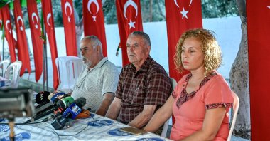 Mehmet Suat Eygi (C), father of Turkish American activist Ayşenur Ezgi Eygi, who was shot dead by Israel in the West Bank, sits next to her uncle Yılmaz Eygi (L), speaks to media near the house of her grandfather, Didim, western Aydın province, Türkiye, Sept.12, 2024. (AFP Photo)