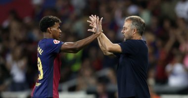 Barcelona's Lamine Yamal (L) and coach Hansi Flick during the La Liga match against Athletic Bilbao at the Lluis Companys Olympic Stadium, Barcelona, Spain, Aug. 24, 2024. (Getty Images Photo)