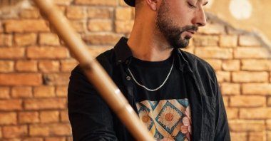 Tayfun Guttstadt holds a ney, a traditional Turkish musical instrument, and poses for the photo. (Tayfun Guttstadt Instagram Photo)
