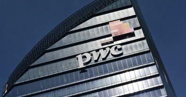 This general view shows the Libeskind Tower (Il Curvo), adorned with the logo of  PricewaterhouseCoopers (PwC), in the business district of Milan, Italy, March 12, 2021. (AFP Photo)