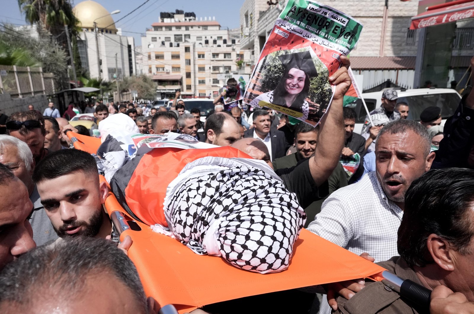 Palestinian people carry the body of slain Turkish American activist Ayşenur Ezgi Eygi, covered with a chequered keffiyeh and the Palestinian flag, during a memorial service, in the occupied West Bank, Palestine, Sept. 9, 2024. (AA Photo)