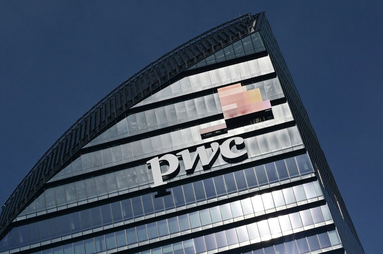 This general view shows the Libeskind Tower (Il Curvo), adorned with the logo of  PricewaterhouseCoopers (PwC), in the business district of Milan, Italy, March 12, 2021. (AFP Photo)