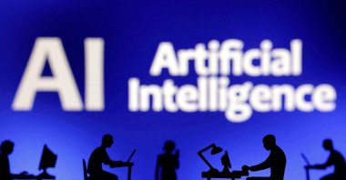 Figurines with computers and smartphones are seen in front of the words "Artificial Intelligence AI" in this illustration taken on Feb. 19, 2024. (Reuters Photo)