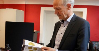 Michael Fornitz, professional numismatist and director of Stack's Bowers auction house, looks at the catalog for the first lot of coins from the coin collection of Danish butter magnate Lars Emil Bruun, Copenhagen, Denmark, Sept. 11, 2024. (Reuters Photo)
