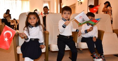 Students proudly display the flags of Türkiye, Azerbaijan and TIKA, Göygöl, Azerbaijan, Sept. 15, 2024. (AA Photo)