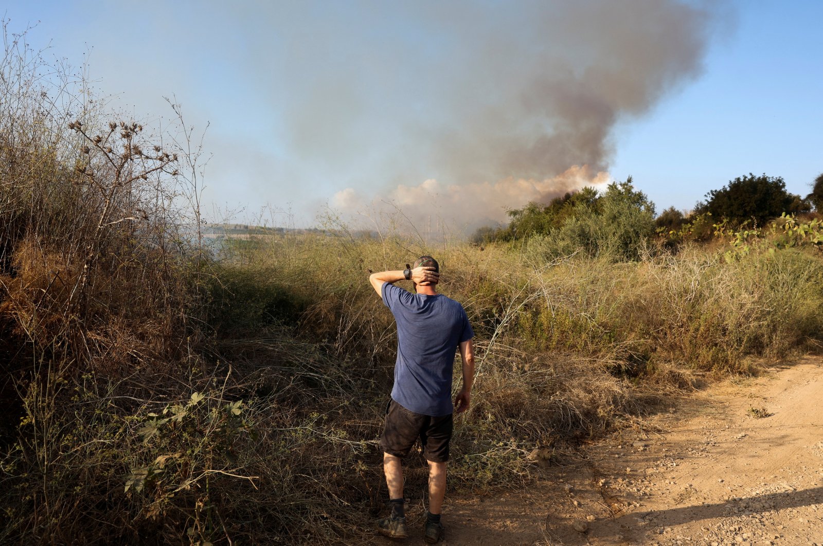 A man looks as smoke billows after a missile attack from Yemen in central Israel, Sept. 15, 2024. (Reuters Photo)