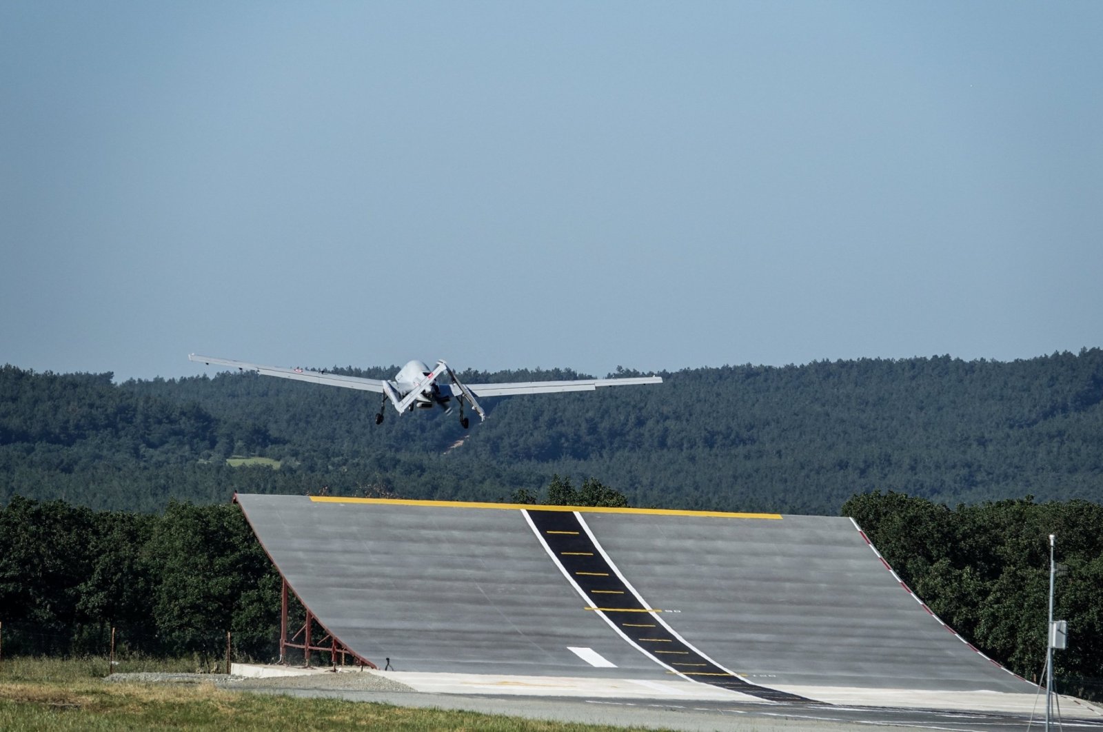 The Bayraktar TB3 combat drone takes off from an upward-curved ramp during a test, Edirne, northwestern Türkiye, June 1, 2024. (AA Photo)