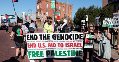 Pro-Palestinian protestors hold up signs and banners along the parade route of the annual Labor Day Parade in Detroit, Michigan, U.S., Sept. 2, 2024. (Reuters Photo)