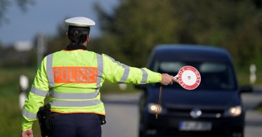 A German police officer stops a vehicle at a border with Denmark as part of random controls in Boeglum, Germany, Sept. 16, 2024. (Reuters Photo)