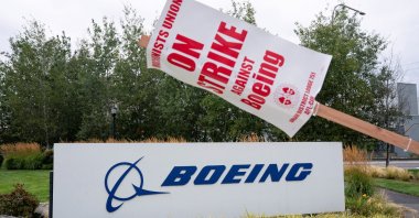 A strike sign hangs from a post near a Boeing sign as Boeing factory workers and supporters gather on a picket line during the third day of a strike near the entrance to a Boeing production facility in Renton, Washington, U.S., Sept. 15, 2024. (Reuters Photo)