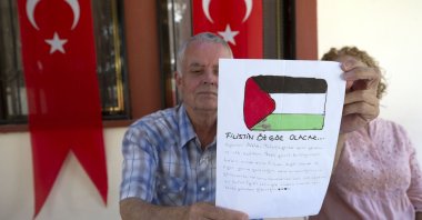 Mehmet Suat Eygi, father of Ayşenur Ezgi Eygi, who was killed by Israel in the West Bank, holds up an anonymous letter addressed to his daughter during an interview at his family home, in the Aegean province of Aydın, Türkiye, Sept. 16, 2024. (AA Photo)