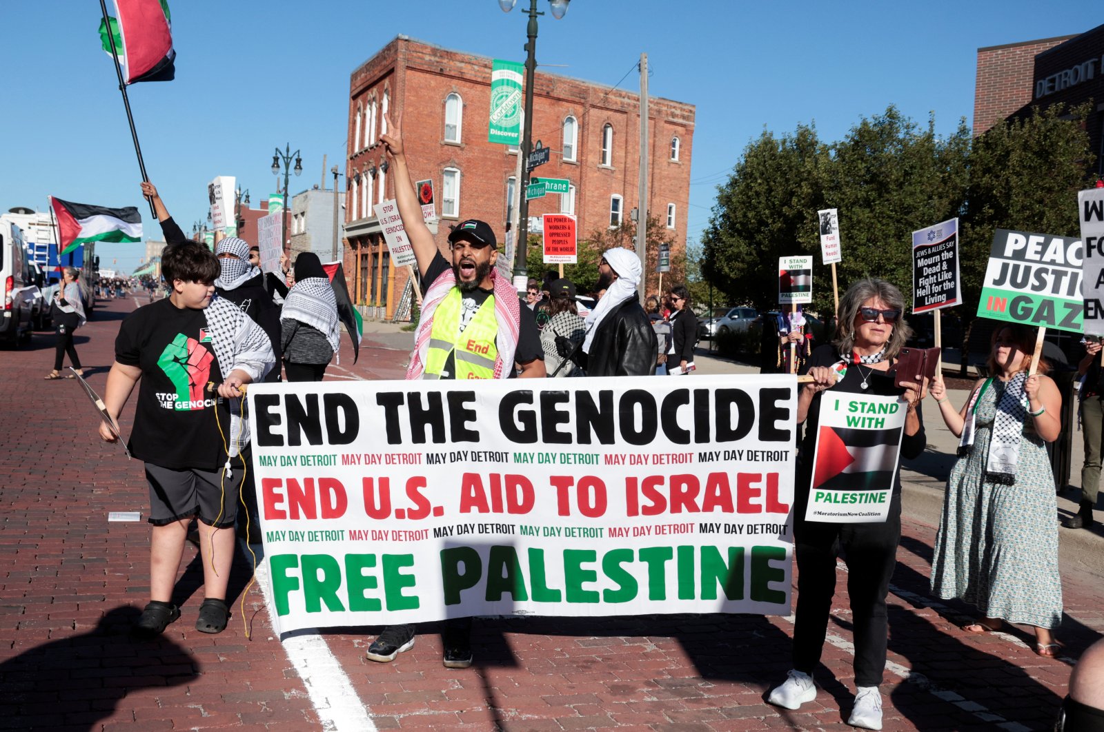 Pro-Palestinian protestors hold up signs and banners along the parade route of the annual Labor Day Parade in Detroit, Michigan, U.S., Sept. 2, 2024. (Reuters Photo)