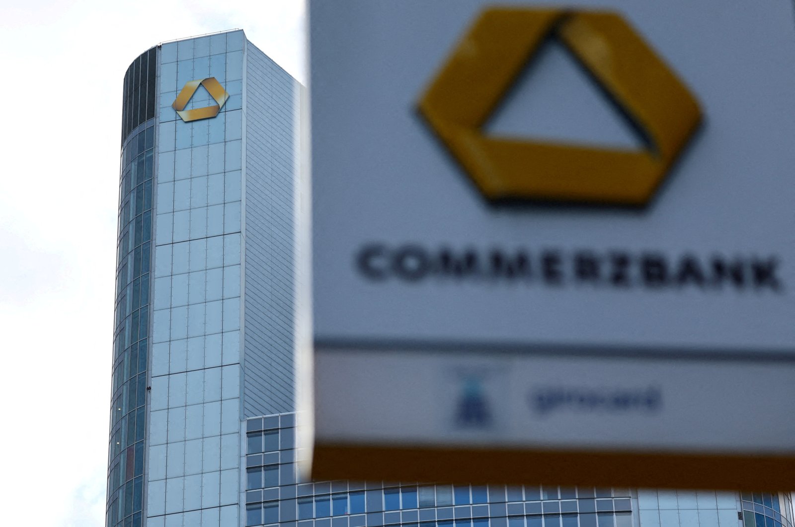 A logo of the bank is seen next to the headquarters of Commerzbank one day ahead of the bank rejoining Germany&#039;s share price index DAX in Frankfurt, Germany, Feb. 26, 2023. (Reuters Photo)