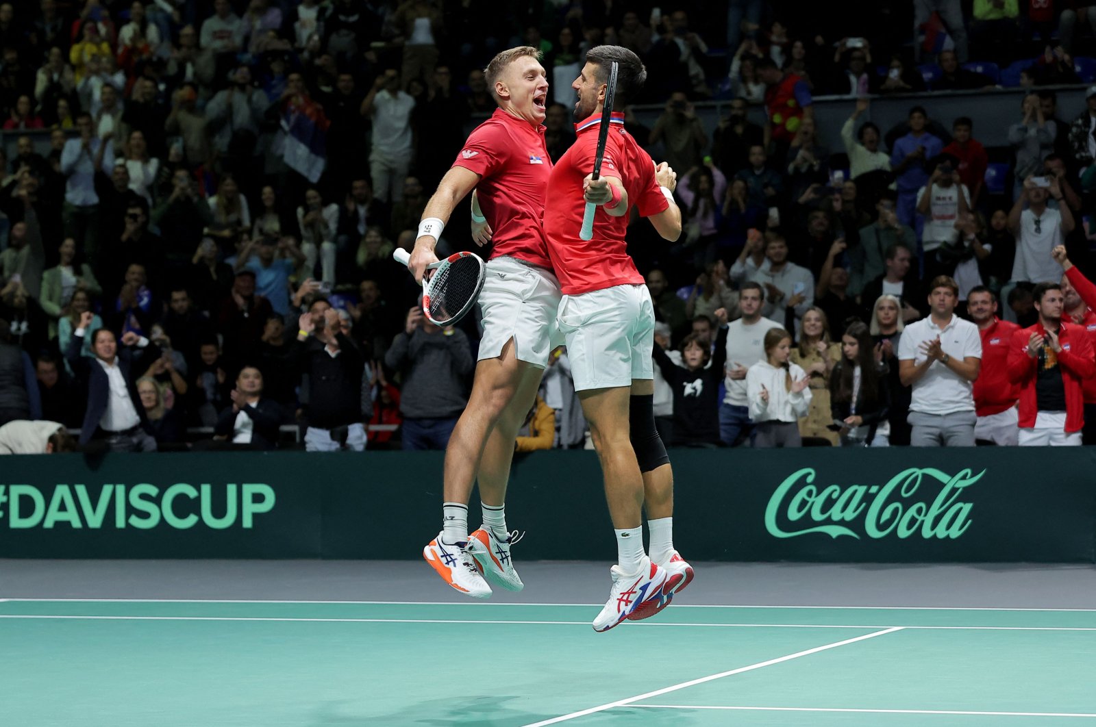 Serbia&#039;s Novak Djokovic (R) and Hamad Medjedovic celebrate after winning against Greece&#039;s Petros Tsitsipas and Aristotelis Thanos during the group stage men&#039;s doubles match between Serbia and Greece of the Davis Cup tennis tournament at the Aleksandar Nikolic Hall, Belgrade, Serbia, Sept. 15, 2024. (AFP Photo)