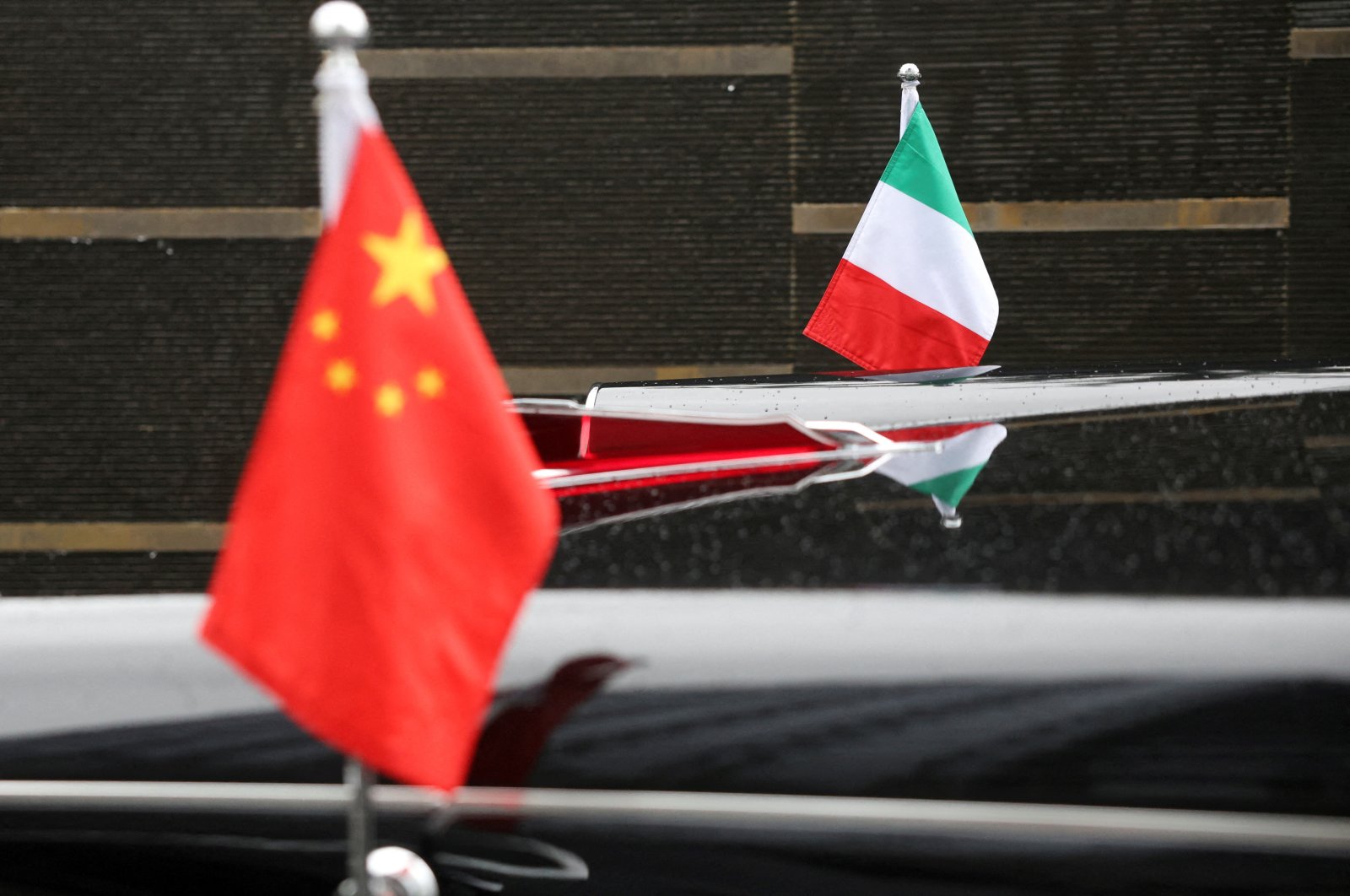 The flags of Italy and China adorn a car outside the venue where Italian Prime Minister Giorgia Meloni spoke to members of the media, Beijing, China, July 30, 2024. (Reuters Photo)