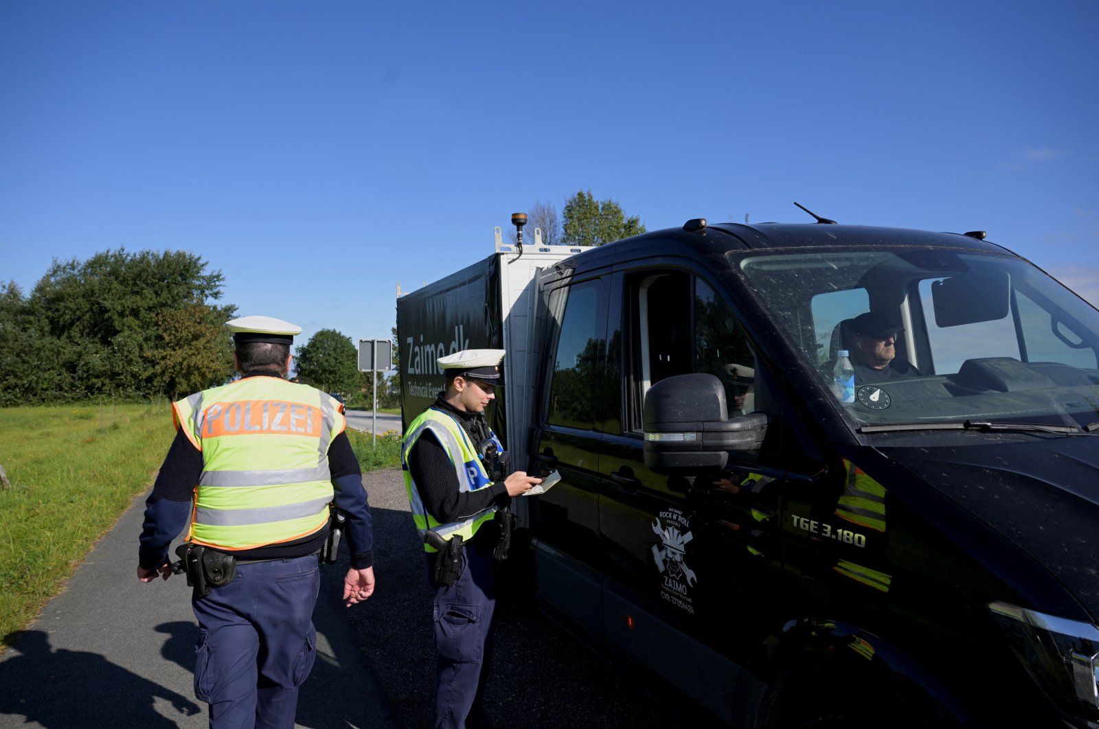 German police officers check a vehicle at a border with Denmark, as all German land borders are subject to random controls, Boeglum, Germany, Sept. 16, 2024. (Reuters Photo)