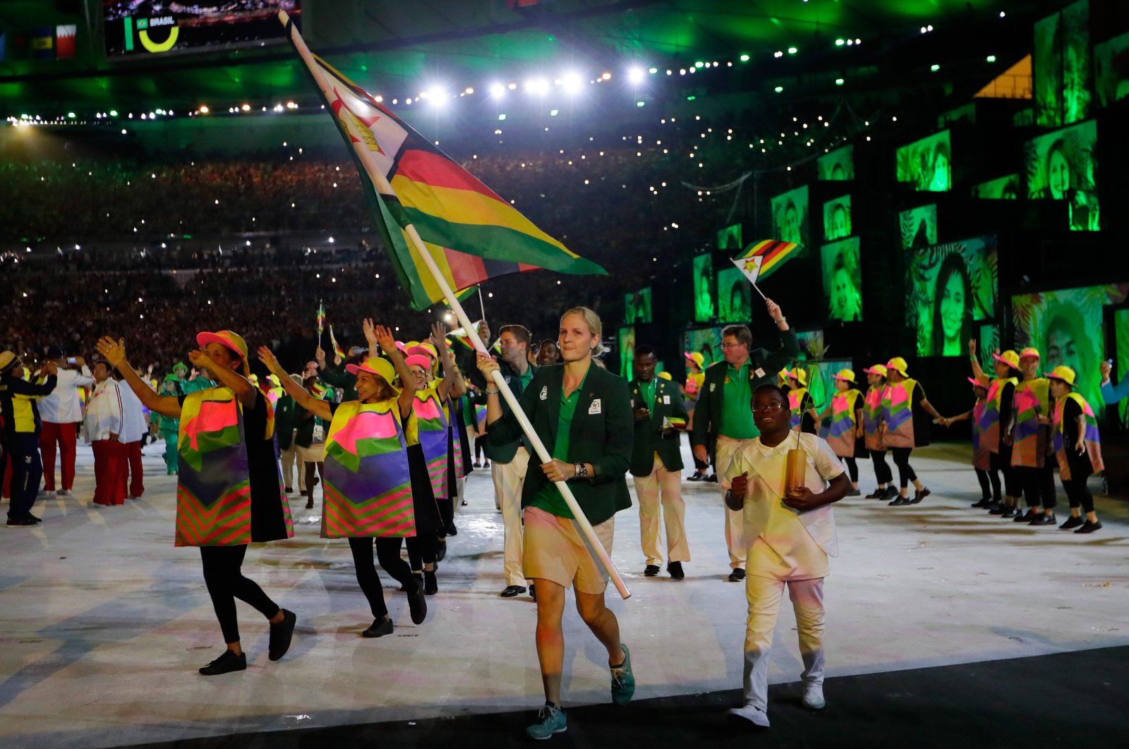 Team Zimbabwe flag bearer Kirsty Coventry (C) leads her team during the opening ceremony of the Rio 2016 Olympic Games at Maracana Stadium, Rio de Janeiro, Brazil, Aug. 5, 2016. (Getty Images Photo)