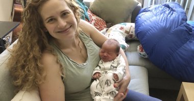 Neuroscientist Liz Chrastil shows her holding her newborn son, Irvine, U.S., May 2020. (Liz Chrastil via AP Photo)