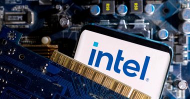 A smartphone with an Intel logo displayed on a computer motherboard is placed in this illustration taken on March 6, 2023. (Reuters Photo)