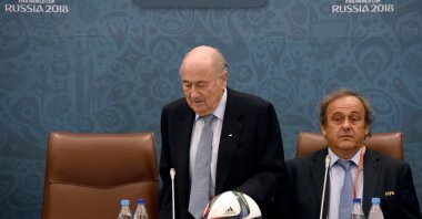 Joseph Blatter (L) takes a seat next to Michel Platini as they join a seminar ahead of the Preliminary Draw for the FIFA World Cup 2018, St. Petersburg, Russia, July 25, 2015. (Getty Images Photo)