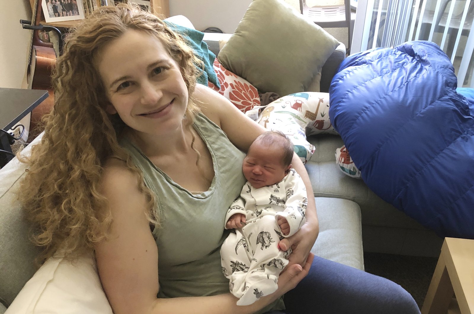 Neuroscientist Liz Chrastil shows her holding her newborn son, Irvine, U.S., May 2020. (Liz Chrastil via AP Photo)