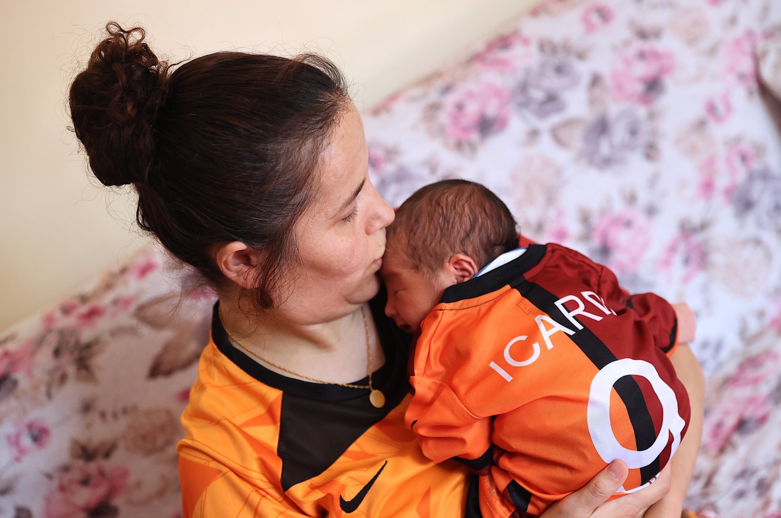 Zehra Ay poses for a photo holding baby Umut Halil Icardi, Mersin, Türkiye, Sept. 11, 2024. (AA Photo)