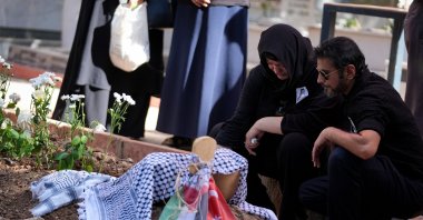 Rabia Birden (2nd R), mother of Ayşenur Ezgi Eygi, weeps by her grave in Didim, Aydın, western Türkiye, Sept. 14, 2024. (AA Photo)
