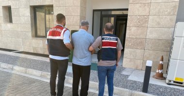 Gendarmerie officers escort a PKK/YPG suspect to the courthouse in western Izmir province, Türkiye, Sept. 18, 2024. (DHA Photo)