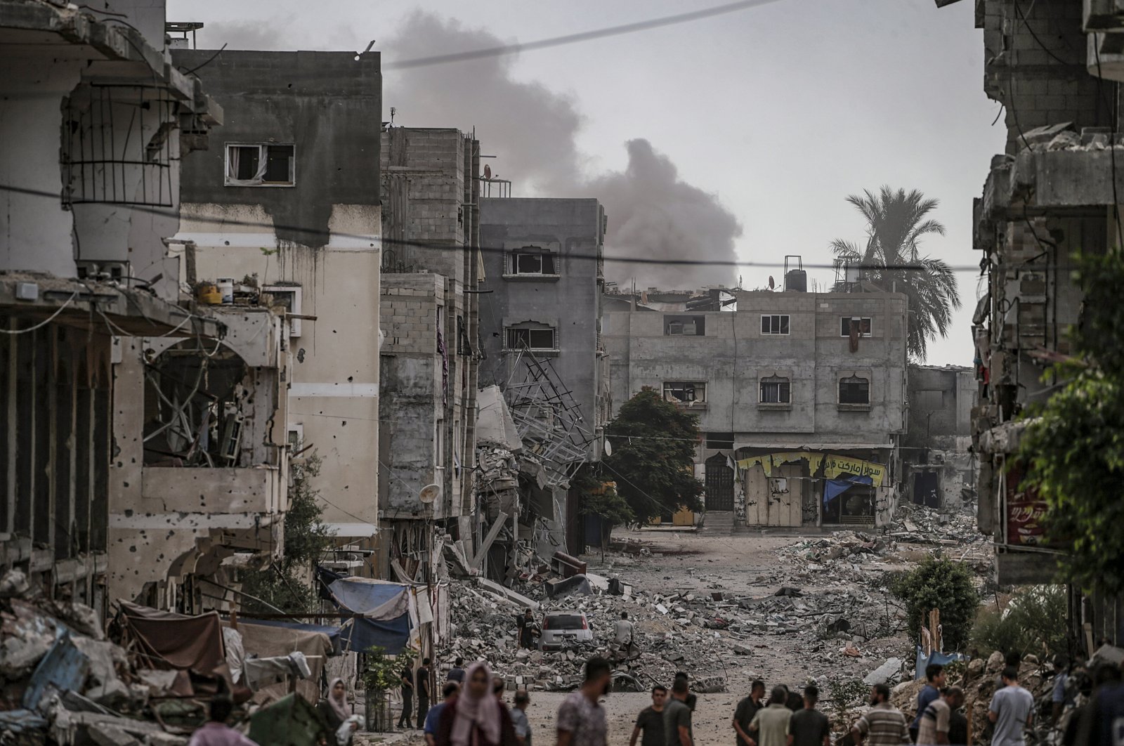 Smoke rises behind buildings following Israeli airstrikes on the al-Bureij refugee camp in the southern Gaza Strip, Palestine, Sept. 17, 2024. (EPA Photo)