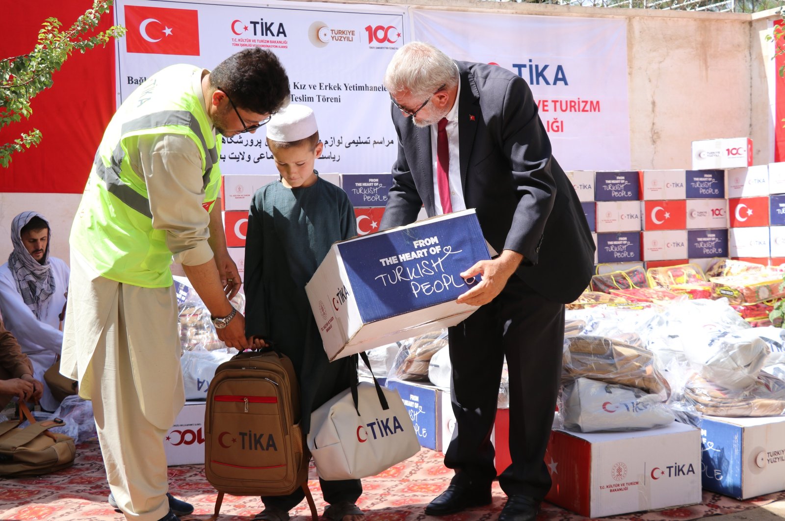 A TIKA team provides school supplies to a student at the orphanage, Baghlan, Afghanistan, Sept. 18, 2024. (AA Photo)