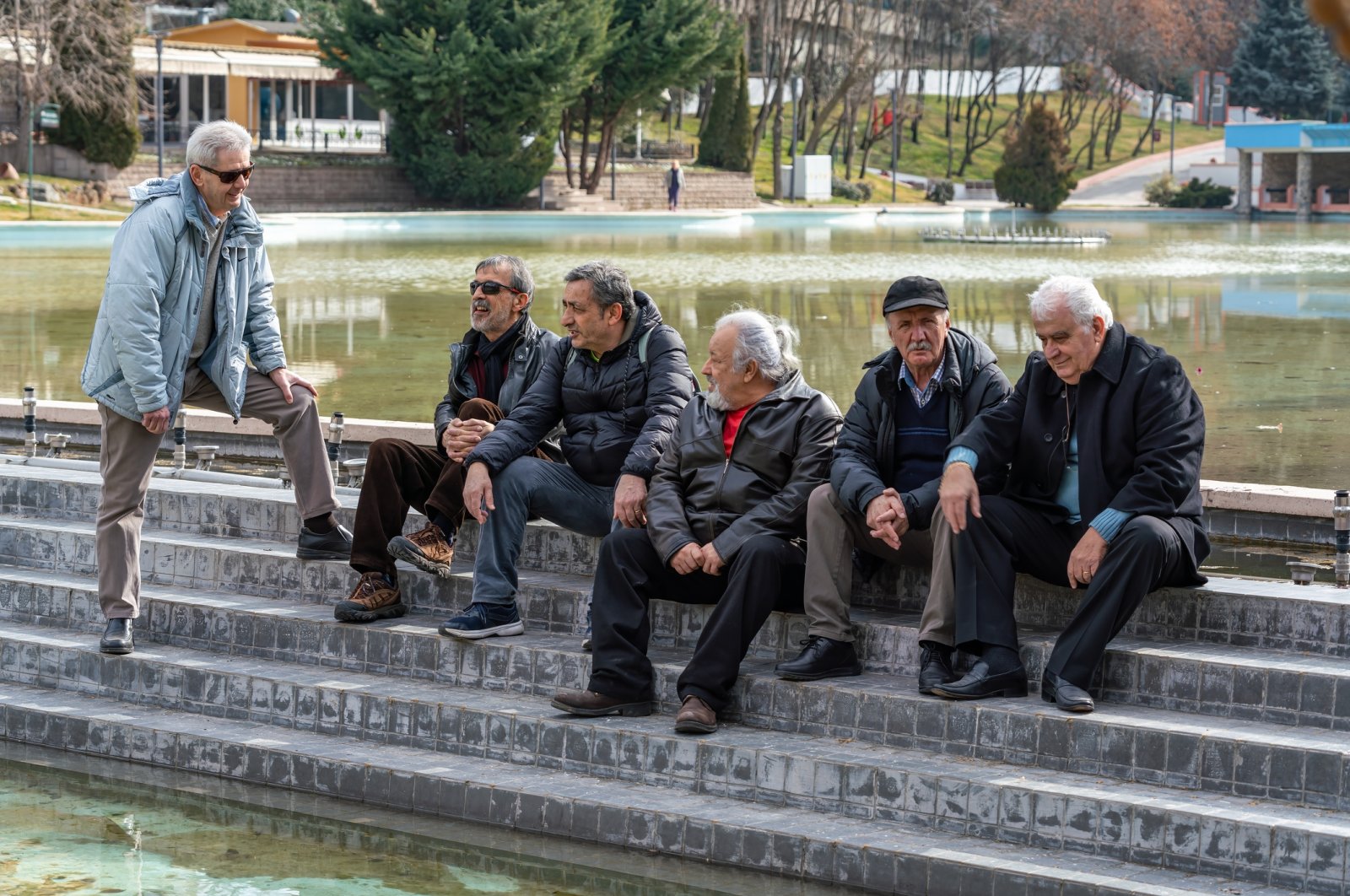 Men gather and chat in a park, Türkiye, Feb. 24, 2023. (Getty Images Photo)