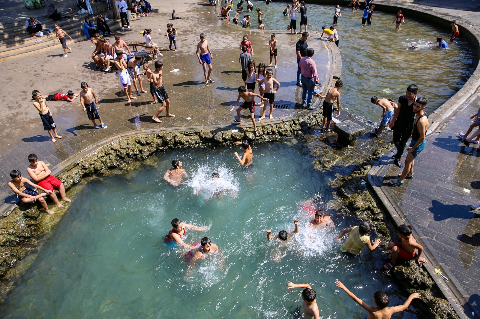 Children cool off in decorative fountains amid the extreme heat in Diyarbakır, Türkiye, May 22, 2024. (AA Photo)