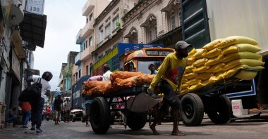 A laborer pulls a handcart loaded with potato sacks in a market area in Colombo, Sri Lanka, Sept. 9, 2024. (Reuters Photo)