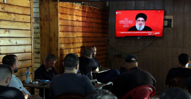 People watch Lebanon&amp;#039;s Hezbollah leader Sayyed Hassan Nasrallah delivering a televised address, as they sit at a cafe in Beirut, Lebanon, Sept.19, 2024. (Reuters Photo)