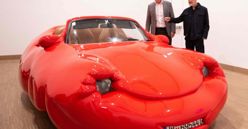 General director of Albertina Klaus Albrecht Schroeder (L) and Austrian artist Erwin Wurm react next to his work &quot;Fat Convertible,&quot; Vienna, Austria, Sept. 12, 2024. (AFP Photo)