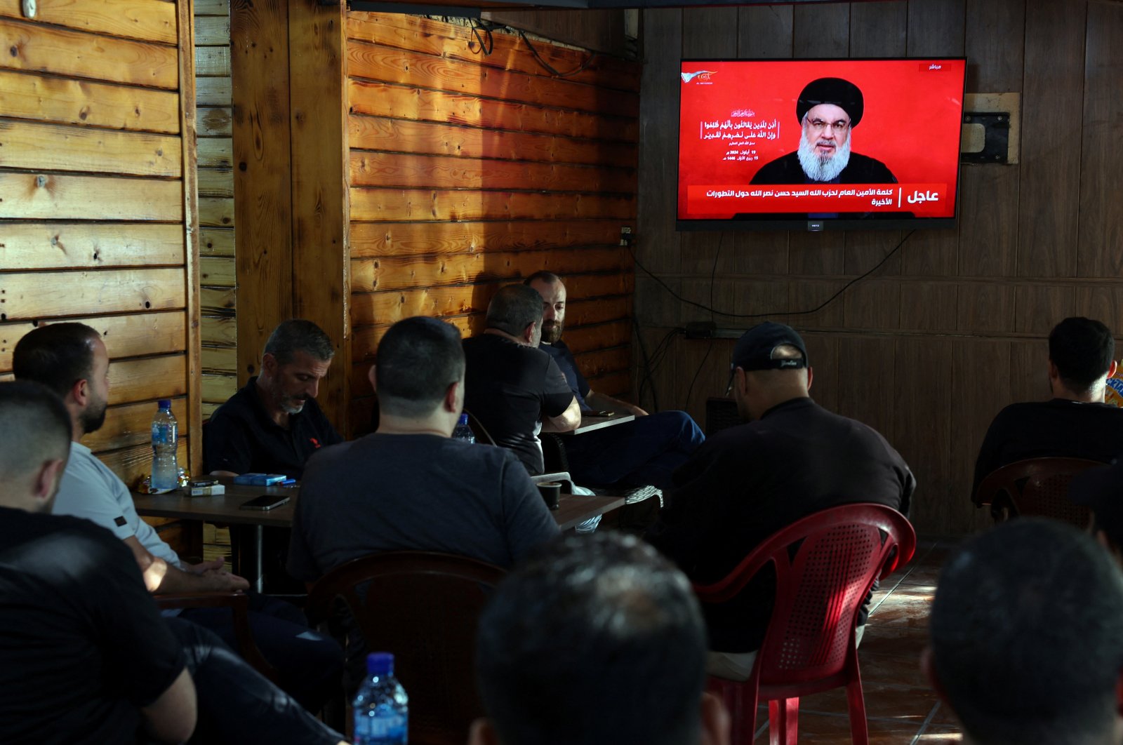 People watch Lebanon&amp;#039;s Hezbollah leader Sayyed Hassan Nasrallah delivering a televised address, as they sit at a cafe in Beirut, Lebanon, Sept.19, 2024. (Reuters Photo)