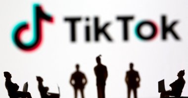 Small toy figures are seen in front of the TikTok logo in this illustration picture taken March 15, 2021. (Reuters Photo)