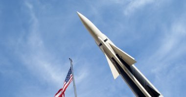 Photo of a missile next to an American flag. (Getty Images Photo)