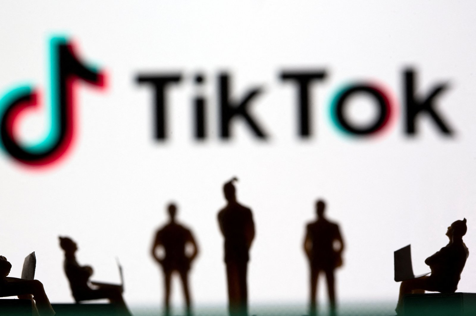 Small toy figures are seen in front of the TikTok logo in this illustration picture taken March 15, 2021. (Reuters Photo)