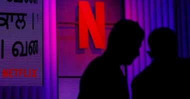 People stand next to the logos of a Netflix during at an event in Mumbai, India, Feb. 29, 2024. (Reuters Photo)