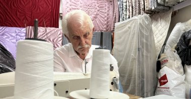 After decades, Ismail Çevikel continues to quilt in his shop, Izmit, Türkiye, Sept. 22, 2024. (IHA Photo) 