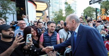 President Recep Tayyip Erdoğan shakes hands with people welcoming him and the first lady outside Turkish House (Türkevi), New York, U.S., Sept. 21, 2024. (AA Photo)