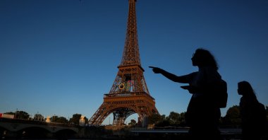 People walk past the Eiffel Tower during the Olympic Games in Paris, France, July 28, 2024. (Reuters Photo)